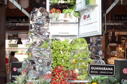 A giant-sized LG refrigerator display in…, with healthy fruits, vegetables and juices flowing from the appliance’s interior like a waterfall.
