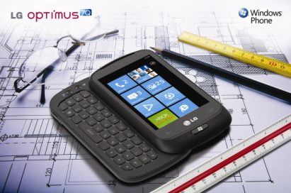 Windows Phone promo shot of The LG Optimus 7Q with slidable keyboard open laid on an architect’s building blueprint, surrounded by rulers, a pencil and a pair of glasses.