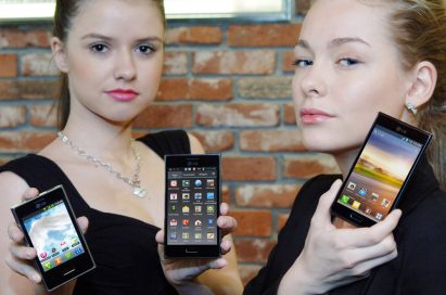 Two female models hold up LG's mobile phones which were designed under the L Design strategy.