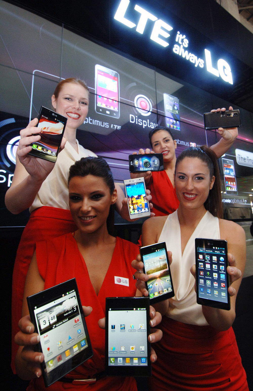 Another image of four female models holding eight LG LTE smartphones at MWC 2012