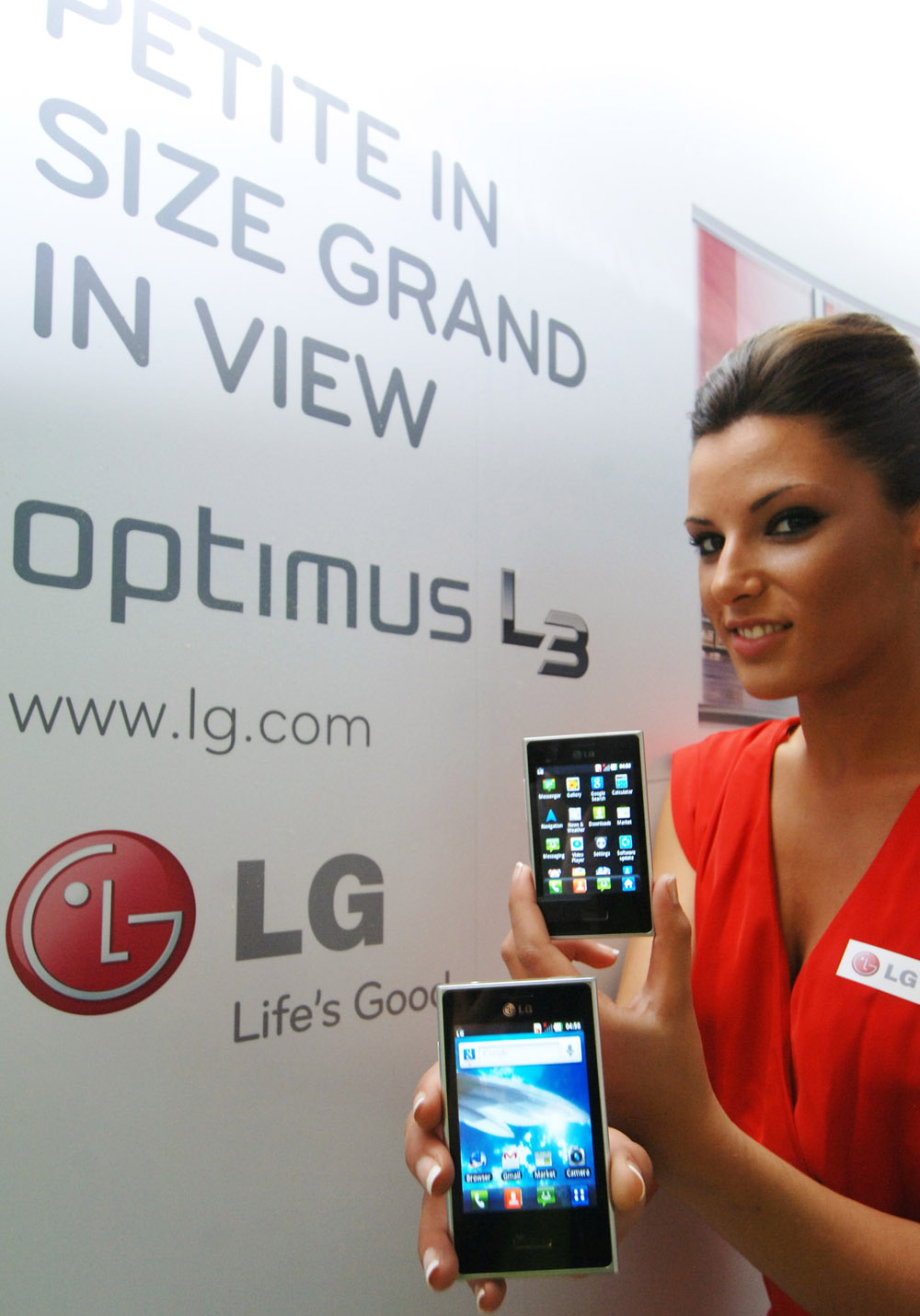 A female model holds an LG new Optimus L3 designed with the L Style design in mind.