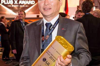 LG Germany president, Young Woong Lee, holding up the Most Innovative Brand of the Year award at the Plus X Awards ceremony