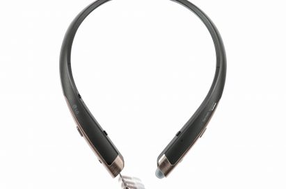 The top view of the LG TONE Platinum™ in Black with Gold trim and the left ear bud extracted from the device