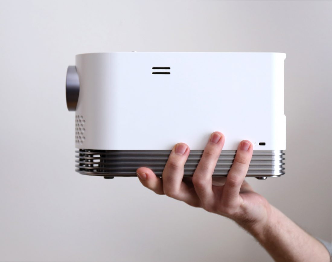 Side view of LG PROBEAM LASER PROJECTOR (MODEL HF80J) lifted by a man's hand