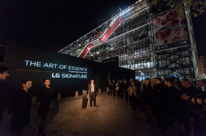 An LG official stands before sign with ‘The Art of Essence’ LG SIGNATURE brand message at opening of LG SIGNATURE Gallery
