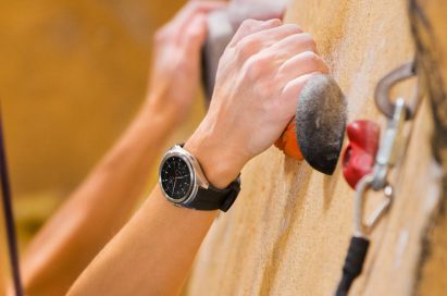 LG Watch Urbane 2 shown on wrist of person doing in-door rock climbing