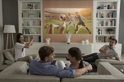 A group of friends use the LG Probeam Projector to watch sport in the living room
