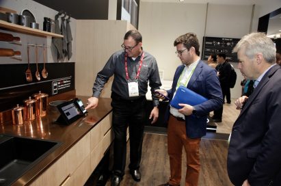 A gentleman demonstrates the enhanced connectivity of LG’s ThinQ AI-powered home appliances to visitors of CES 2018.