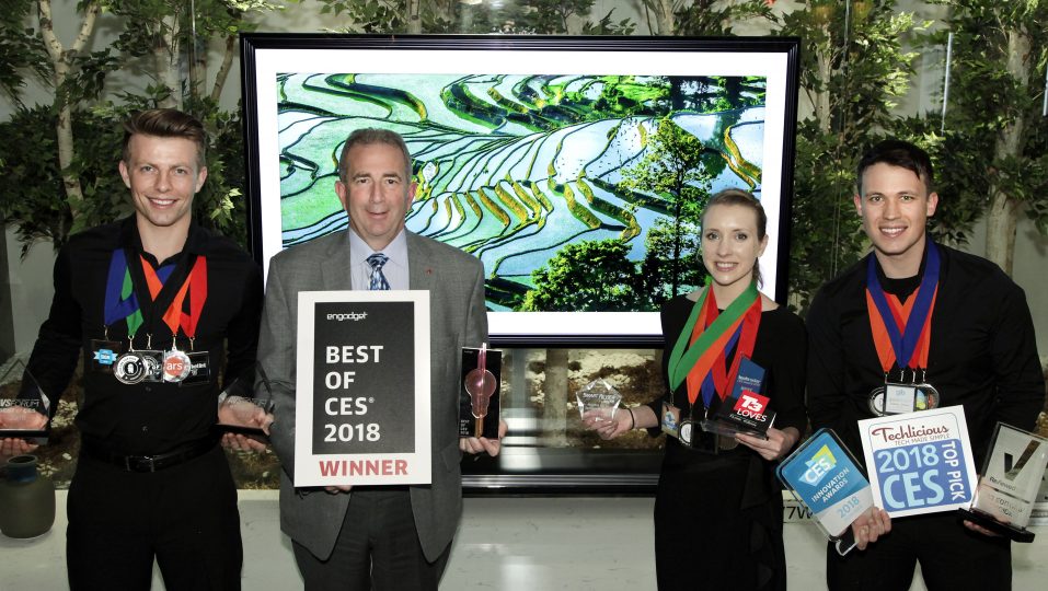 LG Electronics’ USA head of Product Marketing for Home Entertainment Products, Tim Alessi and models pose with awards from Engadget, T3, Techlicious and more, after LG won numerous Best TV product honors at CES 2018.