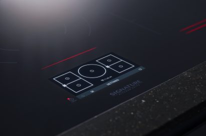 Close-up view of SIGNATURE KITCHEN SUITE cooktop control panel
