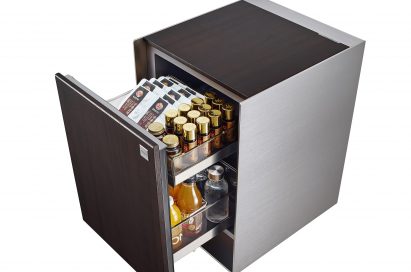 View of LG OBJET Refrigerator with door opened to reveal beverages and skincare products