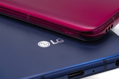 A Carmine Red LG V40 ThinQ is placed faced down on a New Moroccan Blue LG V40 ThinQ smartphone.