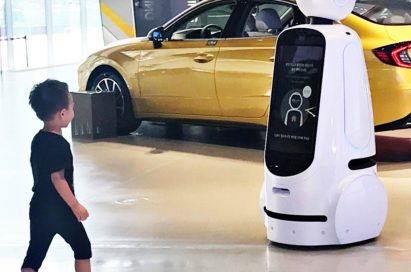 A little boy walks towards LG CLOi GuideBot at the Hyundai Motor Studio Goyang.